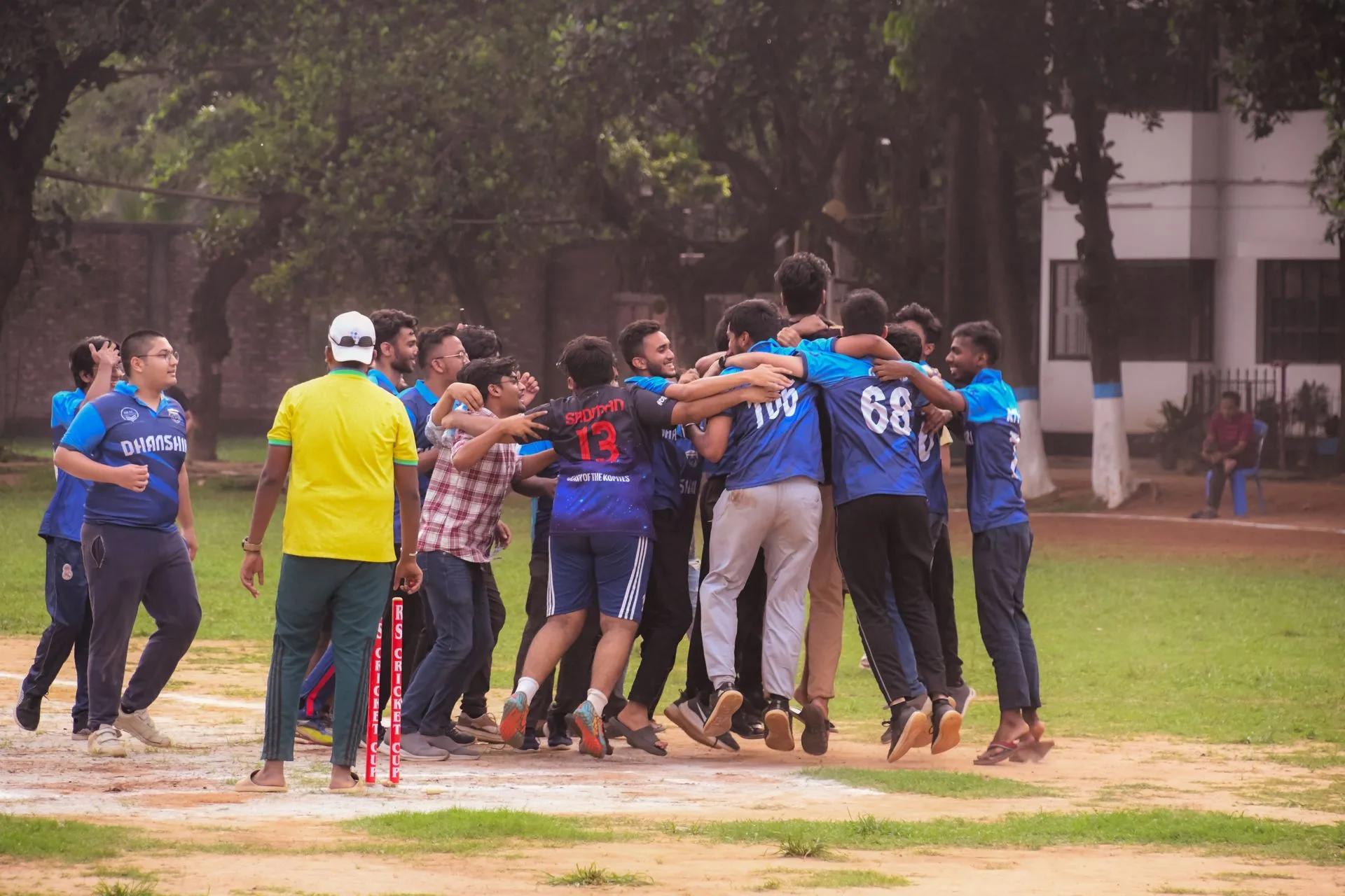 Young cricketers celebrating a win together